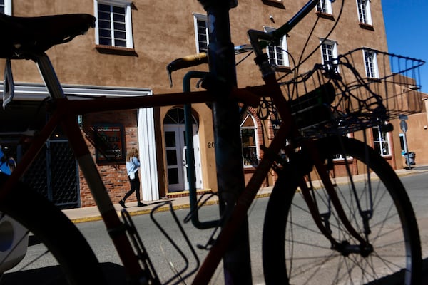 People walk around the Santa Fe Plaza in Santa Fe, New Mexico, Friday, Feb. 28, 2025. (AP Photo/Ty O'Neil)