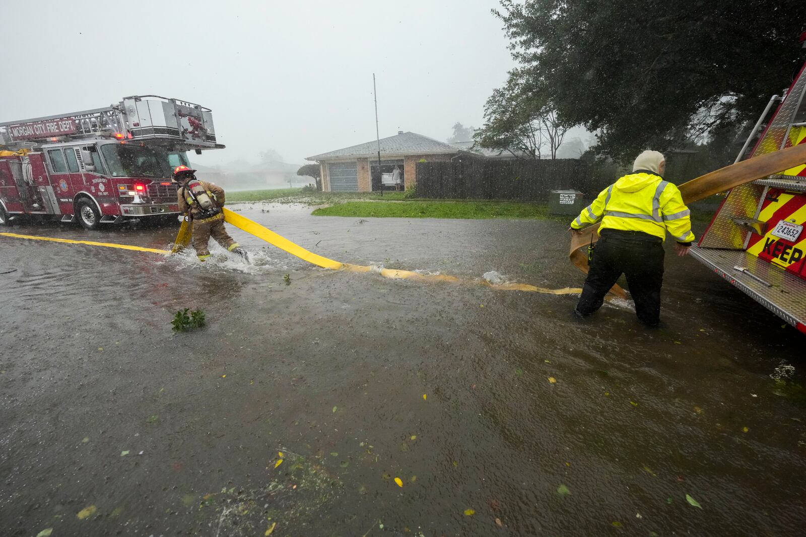 Morgan City firefighters respond to a home fire during Hurricane Francine in Morgan City, La., Wednesday, Sept. 11, 2024. (AP Photo/Gerald Herbert)