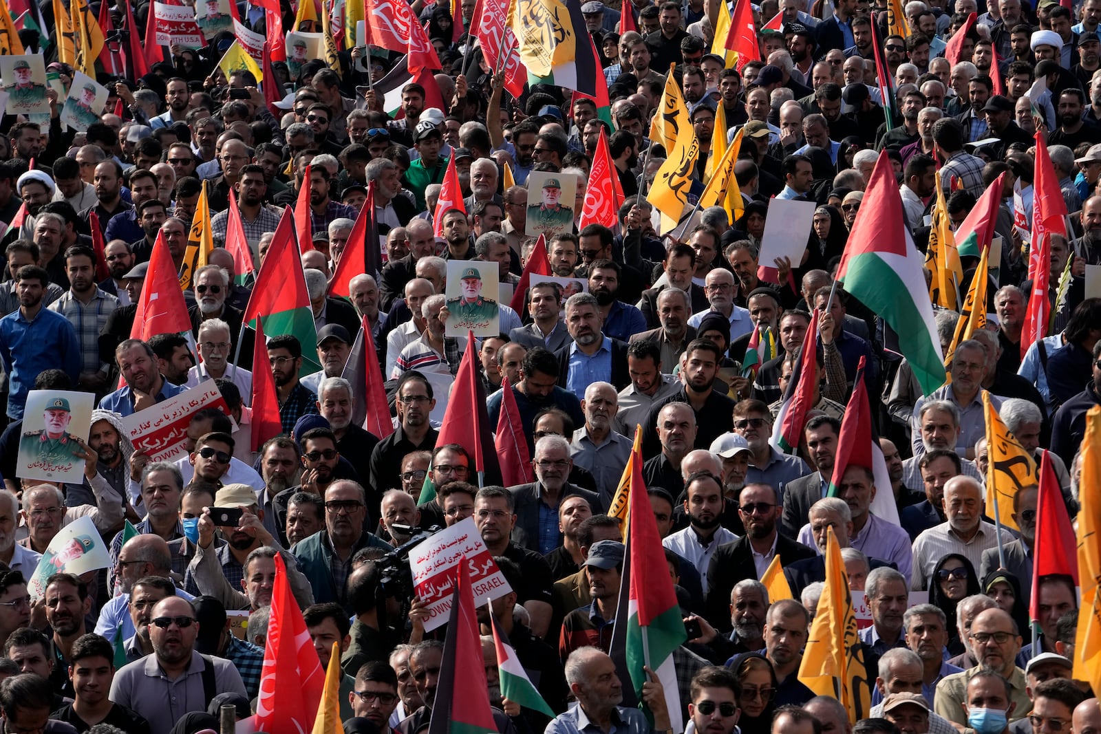 People attend the funeral ceremony of the late Iranian Revolutionary Guard Gen. Abbas Nilforushan, who was killed in an Israeli airstrike in Beirut in late September, in Tehran, Iran, Tuesday, Oct. 15, 2024. (AP Photo/Vahid Salemi)