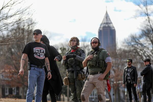 Armed demonstrators - who had earlier attended a rally in Stone Mountain Village  to protest against white nationalists - keep watch during a rally in Piedmont Park  Saturday, Feb. 2, 2019. The Atlanta event was sponsored by the NAACP, the Southern Christian Leadership Conference, the Southern Poverty Law Center and activist groups Alliance for Black Lives and Georgia Alliance for Social Justice to spotlight racial inequality in the state.  (Photo: BRANDEN CAMP/SPECIAL)