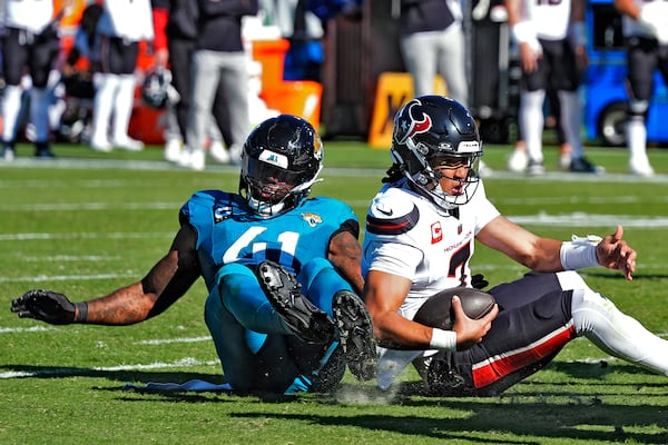 Jacksonville Jaguars defensive end Josh Hines-Allen (41) sacks Houston Texans quarterback C.J. Stroud (7) during the first half of an NFL football game Sunday, Dec. 1, 2024, in Jacksonville, Fla. (AP Photo/John Raoux)