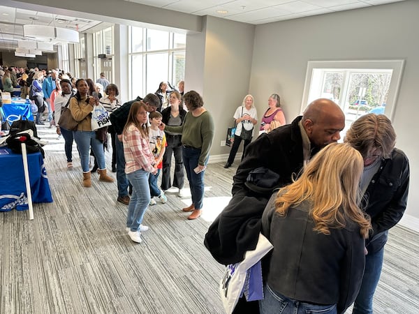 Eugene Comer of Stone Mountain quietly sang a Lauren Daigle song "Be Okay" to Kevin Avery and Taylor Scott at the Fish 104.7 going away party at Mt. Paran Church Saturday, Jan. 25, 2025, six days before the station officially closed its doors. RODNEY HO/rho@ajc.com