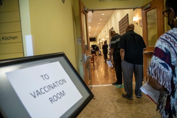 People wait to get their second COVID-19 vaccination shot at a COVID-19 vaccination event at the Lou Walker Senior Center in Stonecrest in February. (Alyssa Pointer / Alyssa.Pointer@ajc.com)