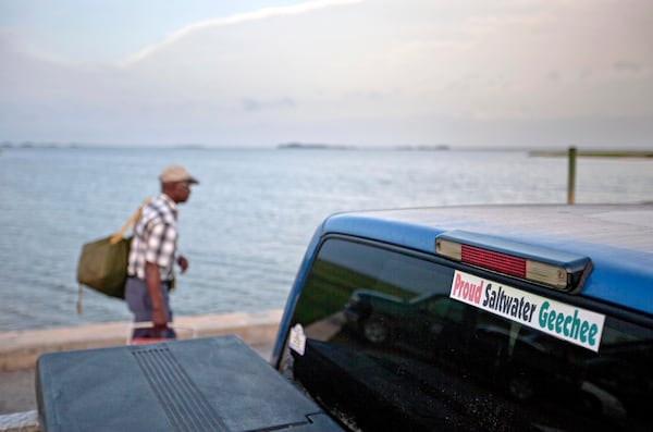 In this file photo, a sticker celebrating the Geechee heritage is seen on a truck as passengers board a ferry to the mainland from Sapelo Island, Ga. 