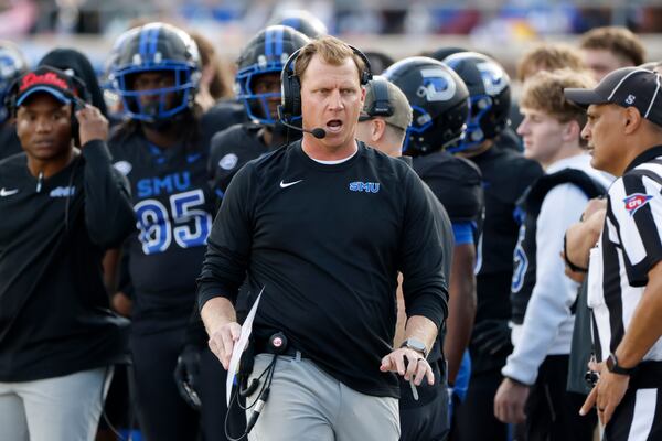 SMU head football coach Rhett Lashlee, center, argues a call during the first half of an NCAA college football game against Boston College, in University Park, Texas, Saturday, Nov. 16, 2024. (AP Photo/Michael Ainsworth)