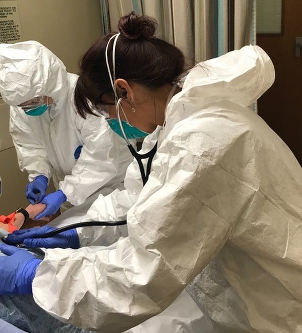 Dr. Kathleen Funk and RN Amanda Tubbs evaluate a potential COVID-19 patient at Northside Hospital in March. CONTRIBUTED PHOTO