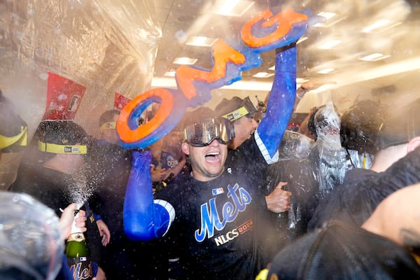 FILE - The New York Mets celebrate in the clubhouse after defeating the Philadelphia Phillies in Game 4 of the National League divisional baseball playoff series, Wednesday, Oct. 9, 2024, in New York. (AP Photo/Frank Franklin II, FIle)