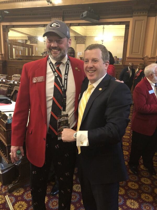 Georgia Reps. Barry Fleming, R-Harlem, and Bert Reeves, R-Marietta, meet on the floor of the Georgia House before the national college football championship game Monday night. Fleming is pulling for Georgia, but Reeves is a suffering Georgia Tech fan. MARK NIESSE / MARK.NIESSE@AJC.COM