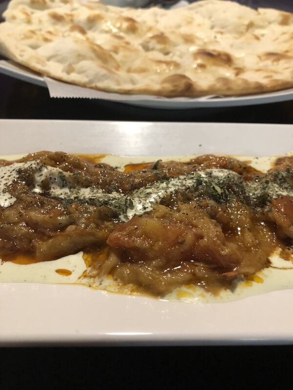 The banjan appetizer at Ariana Kabob House: creamy smashed eggplant with garlic, tomato and yogurt, served with warm puffy naan. CONTRIBUTED BY WENDELL BROCK