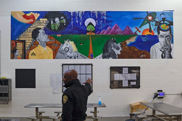 Colonel Temetris Atkins, commander at Cobb County Detention Center, stands in front of a mural inside the veterans pod in the compliance dorms on Wednesday, November 2, 2022. (Natrice Miller/natrice.miller@ajc.com)  