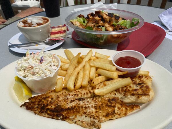 Downwind offers traditional bar and grill fare. Pictured is a grilled flounder plate with fries and coleslaw; a Caesar salad with blackened chicken; and a cup of chili. Ligaya Figueras/ligaya.figueras@ajc.com
