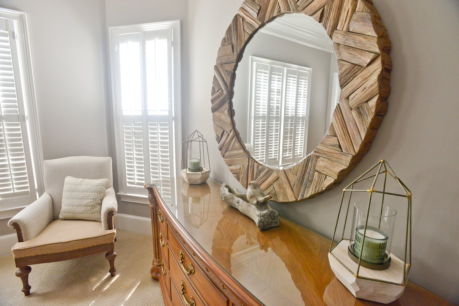 Round mirror and driftwood decor