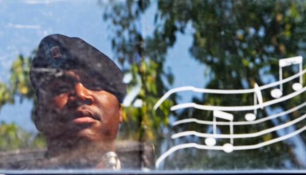 Sgt. Alvin Tanner, a trumpet player for the 116th Army Georgia National Guard Ceremonial Brass, is reflected in his music stand during the 2016 City of Smyrna Memorial Day Ceremony.