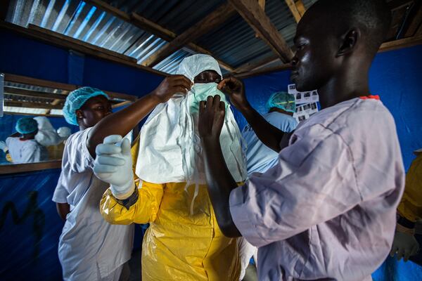 A nurse prepares to go inside an Ebola ward in Liberia in October 2014. CONTRIBUTED BY MORGANA WINGARD, COURTESY OF USAID SUAKOKO