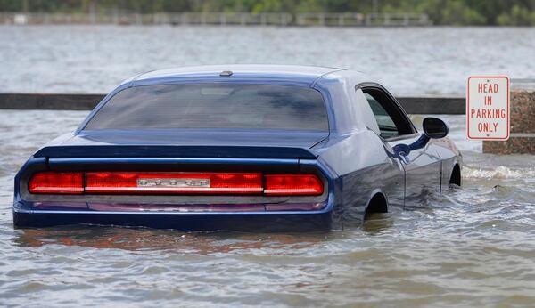 A car parked on River Street in Savannahm Ga., is surrounded by floodwater from the Savannah River, Monday, Sept. 11, 2017, after Hurricane Irma moved through. (Dash Coleman/Savannah Morning News via AP)