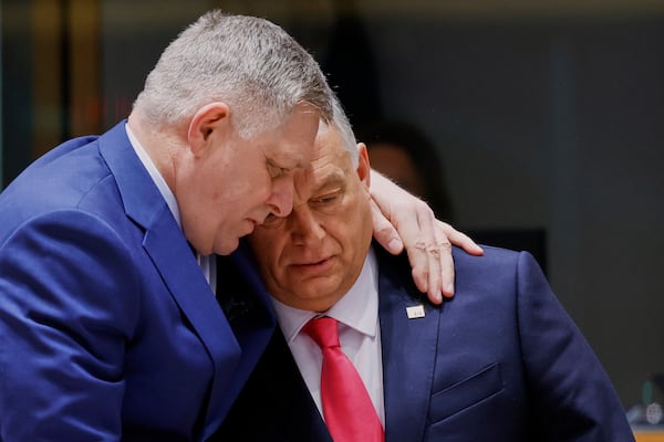 Slovakia's Prime Minister Robert Fico, left, speaks with Hungary's Prime Minister Viktor Orban during a round table meeting at an EU summit in Brussels, Thursday, March 20, 2025. (AP Photo/Omar Havana)