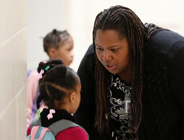 Dione Simon Taylor stops to speak to students during her morning routine.  Bob Andres / robert.andres@ajc.com