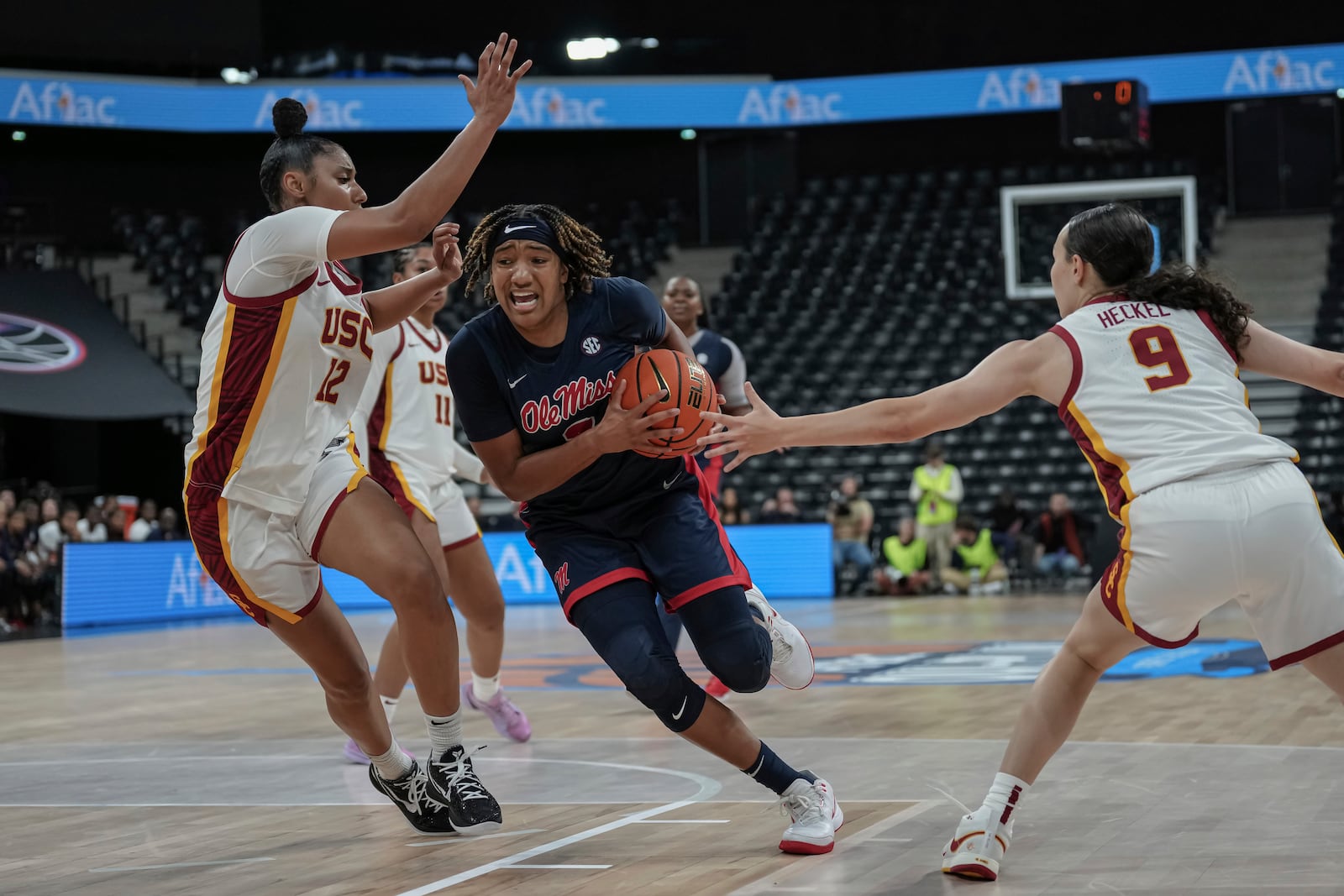 Ole Miss's guard Kennedy Todd-Williams, center, competes for the ball against USC Trojans's guard Juju Watkins, left, during the basketball match between the University of Southern California (USC) and Ole Miss, Monday, Nov. 4, 2024 in Paris, France. (AP Photo/Aurelien Morissard)