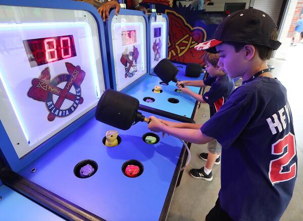 Gavi and Noah play a game of chop a mole in the kids friendly area of SunTrust Park as part of the Braves Exceptional Fans Program. Curtis Compton/ccompton@ajc.com