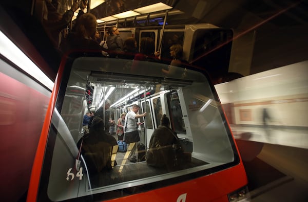 Passengers travel on the automated people movers on their way to baggage claim after arriving at Hartsfield-Jackson Atlanta International Airport Tuesday morning in Atlanta. JASON GETZ / JGETZ@AJC.COM