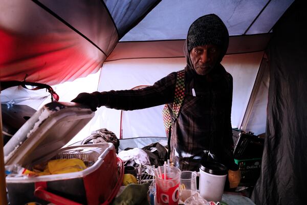 Rudolph "Pops" Earley shows a cooler where he keeps food safe from rats inside his tent. He and other homeless residents from a Buckhead encampment known as "The Hill" received help from nonprofits including the Elizabeth Foundation, an organization that provides resources to homeless people from food, clothes, cleaning supplies, and shelter.
Miguel Martinez / miguel.martinezjimenez@ajc.com