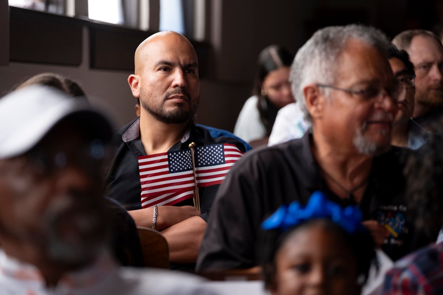 Salvador Ochoa sits in the audience during a Naturalization ceremony at Jimmy Carter National Historic Park in Plains on Tuesday, Oct. 1, 2024 where his wife became a U.S. citizen. The ceremony was held in honor of President Carter’s 100th birthday.  Ben Gray for the Atlanta Journal-Constitution