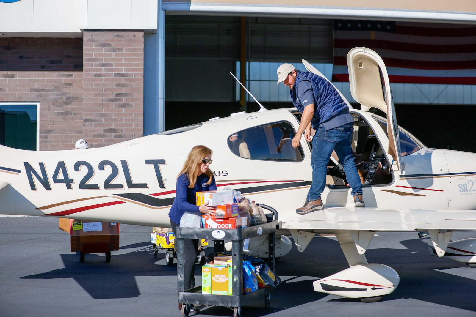 Jeanine Chambers (left) executive director with Angel Flight Soars, helps Andres Murillo load a plane a DeKalb-Peachtree Airport.