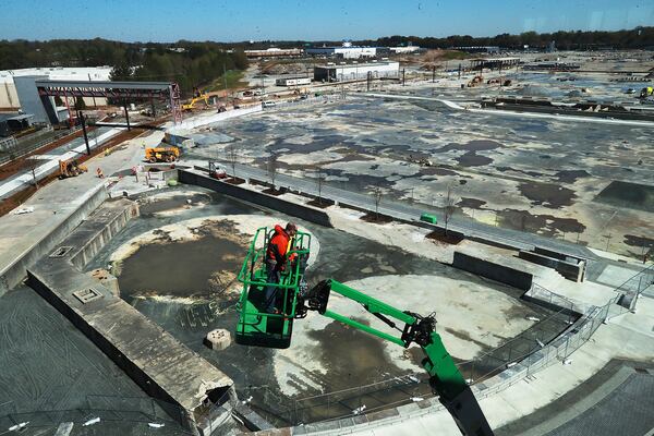 A worker on a lift outside the new Serta Simmons Bedding building overlooks the Assembly development, a mini-city slated for the site of the old General Motors plant. (Photo: Curtis Compton / ccompton@ajc.com)