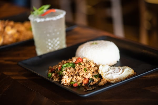 Rickshaw Thai Street Food Street Basil Chicken with diced bell peppers and onions, and fresh basil, served with a fried egg. (Mia Yakel for The Atlanta Journal-Constitution)