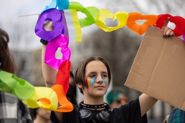 Valentino Branum Martin, 12, participates in a rally outside the Capitol in Atlanta on Tuesday, March 4, 2025, as groups stage a protest and “lobby day” to protest anti-LGBTQ+ measures. (Arvin Temkar/AJC)