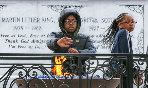 Malik Shaeer, 12 (left), and Deja Reynolds, 12, from Minneapolis visit the crypt of Martin Luther King Jr. and Coretta Scott King on Wednesday. JOHN SPINK/JSPINK@AJC.COM