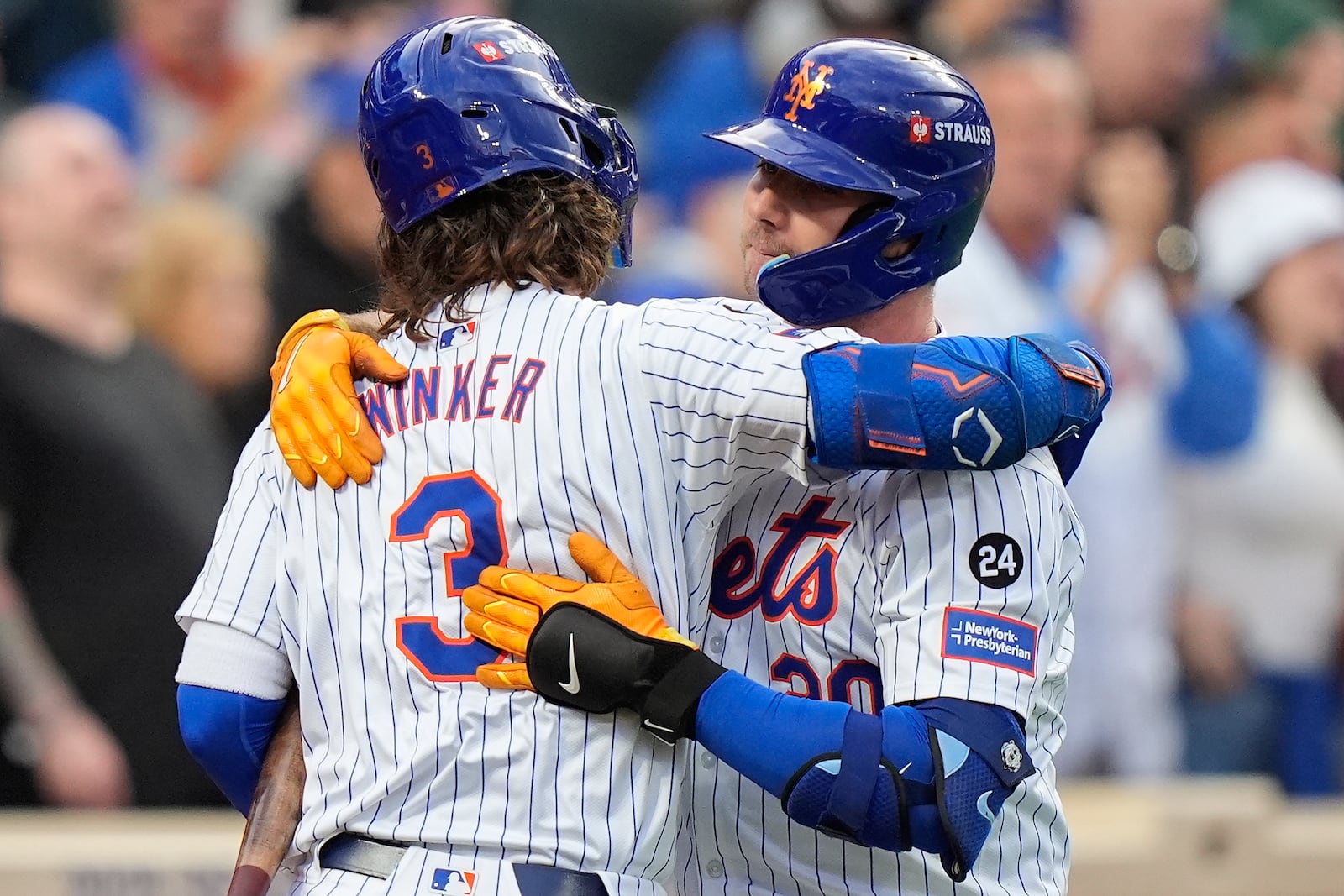 New York Mets' Pete Alonso (20) hugs Jesse Winker (3) after hitting a solo home run against the Philadelphia Phillies during the second inning of Game 3 of the National League baseball playoff series, Tuesday, Oct. 8, 2024, in New York. (AP Photo/Frank Franklin II)