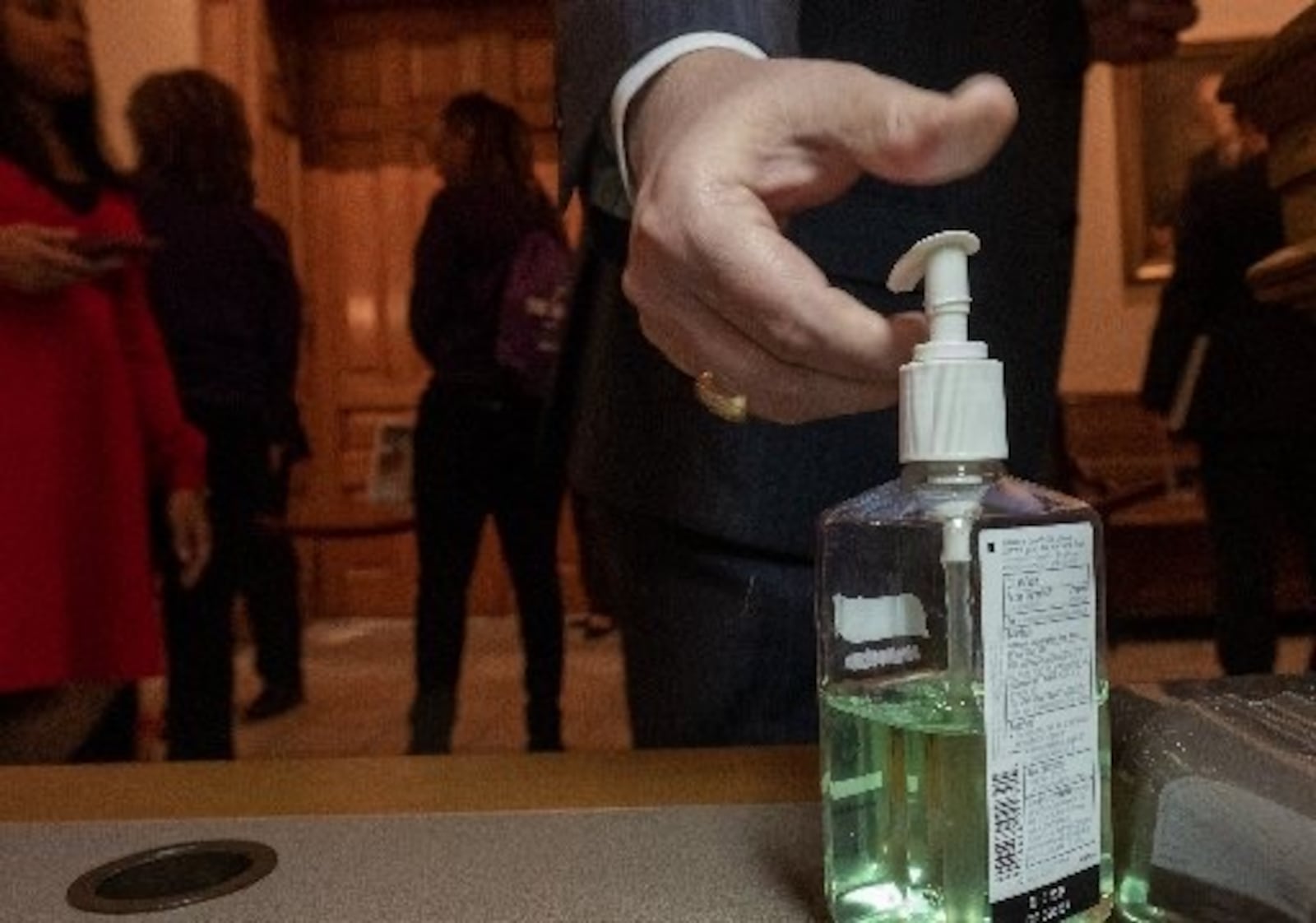 A lawmaker uses hand sanitizer at the Capitol. AJC/Ben Gray