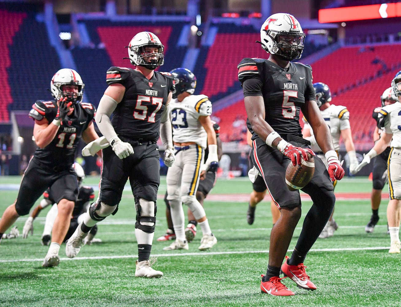 North Oconee’s Khamari Brooks (5) carries the ball for a Titan touchdown against Marist during the first half of a Class 4A championship game at the Mercedes-Benz Stadium Monday, Dec. 16, 2024. (Photo/Daniel Varnado)