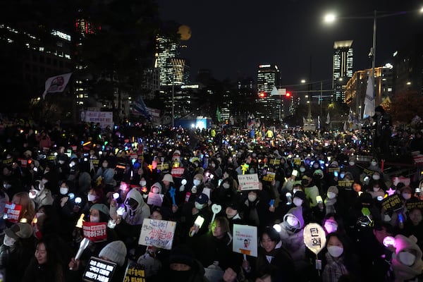 Protesters stage a rally to demand South Korean President Yoon Suk Yeol's impeachment outside the National Assembly in Seoul, South Korea, Thursday, Dec. 12, 2024. The banners read "Impeachment ." (AP Photo/Lee Jin-man)