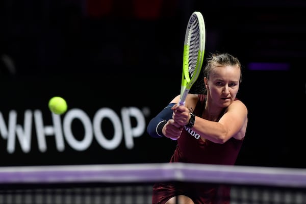 Czech Republic's Barbora Krejcikova, in action with China's Qinwen Zheng during women's singles semi final match at King Saud University Indoor Arena, in Riyadh, Saudi Arabia, Friday, Nov. 8, 2024. (AP Photo)