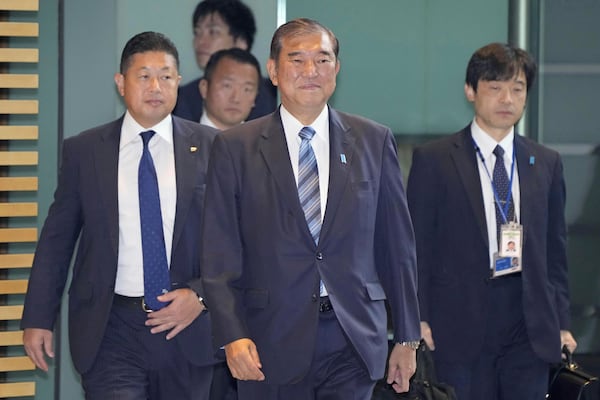 Japanese Prime Minister Shigeru Ishiba, center, arrives at his office in Tokyo Monday, Nov. 11, 2024. (Kyodo News via AP)