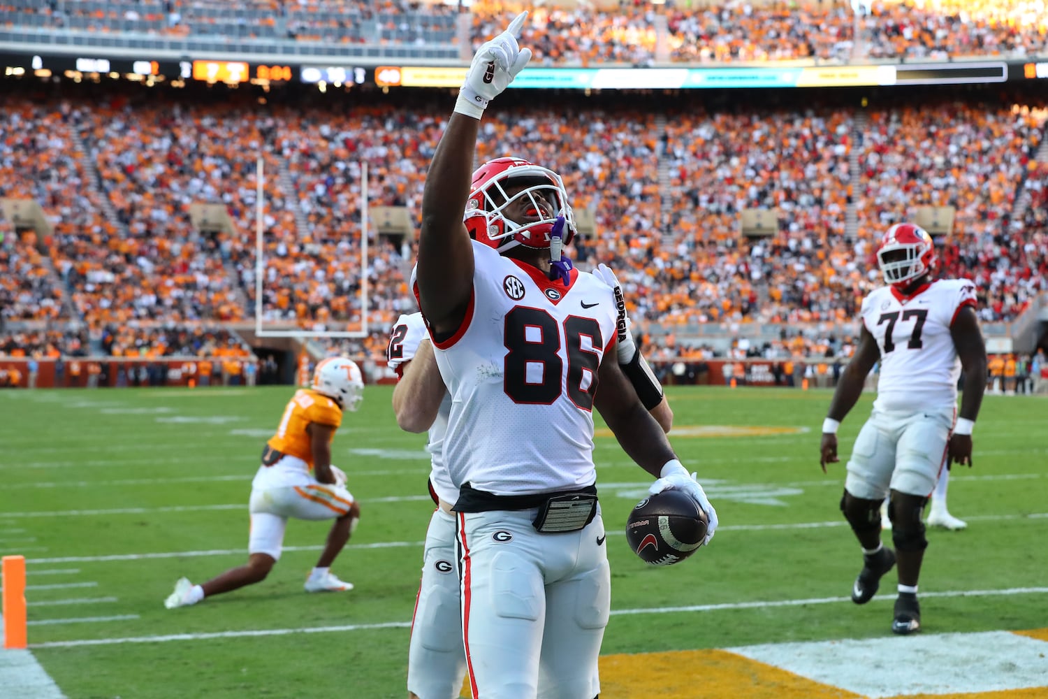 Georgia wide receiver Dillon Bell reacts in the end zone after breaking away from Tennessee defender Gabe Jeudy-Lally (left) for a touchdown to take a 17-7 lead during the second quarter in a NCAA college football game on Saturday, Nov. 18, 2023, in Knoxville.  Curtis Compton for the Atlanta Journal Constitution