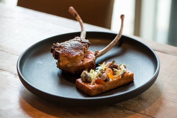  Pork Chop with black eyed pea panisse, Georgia peach, frisse, choucroute, and peach bordelaise. Photo credit- Mia Yakel.