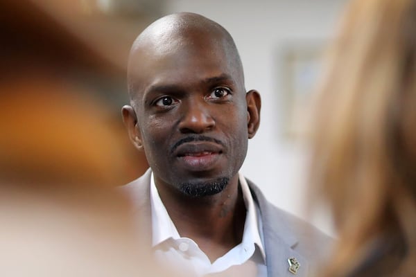 South Fulton mayor-elect Khalid Kamau speaks with Old National Merchants Association members during a toy drive on Thursday, December 9, 2021. Miguel Martinez / The Atlanta Journal-Constitution