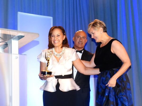 11 Alive anchor Brenda Wood accepts the best newscast Emmy with her boss (right) Ellen Crooke. CREDIT: Rodney Ho/rho@ajc.com