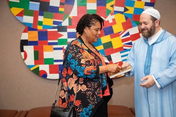 Muhammad al-Ninowy greets a guest at “The Book of Love” launch ceremony held Sunday at The Carter Center. SARA ABUGIDEIRI / WESTERLY PHOTOGRAPHY