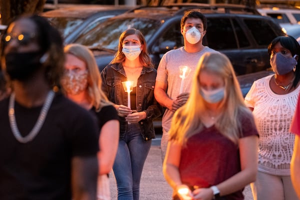 Abby Self, left, and  Dakota Palmisano attend a memorial service for Kyle Gregory at Brookwood High School on Friday evening July 24, 2020. (Ben Gray for the Atlanta Journal-Constitution)