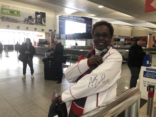 Super Bowl volunteer Jacqueline Moffett shows off her autographed jacket signed by former Falcon Asante Samuel. ARLINDA SMITH BROADY/AJC