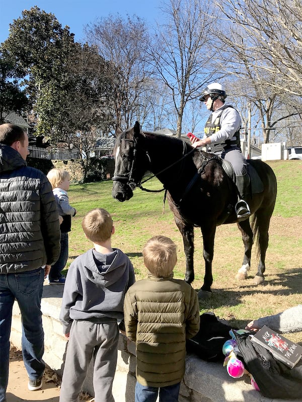 Lt. Greg Lyon and his horse, Drifter, greet kids at Ormond-Grand Park on a recent Sunday afternoon. (Photo: Holly Elrod/Special to The AJC)