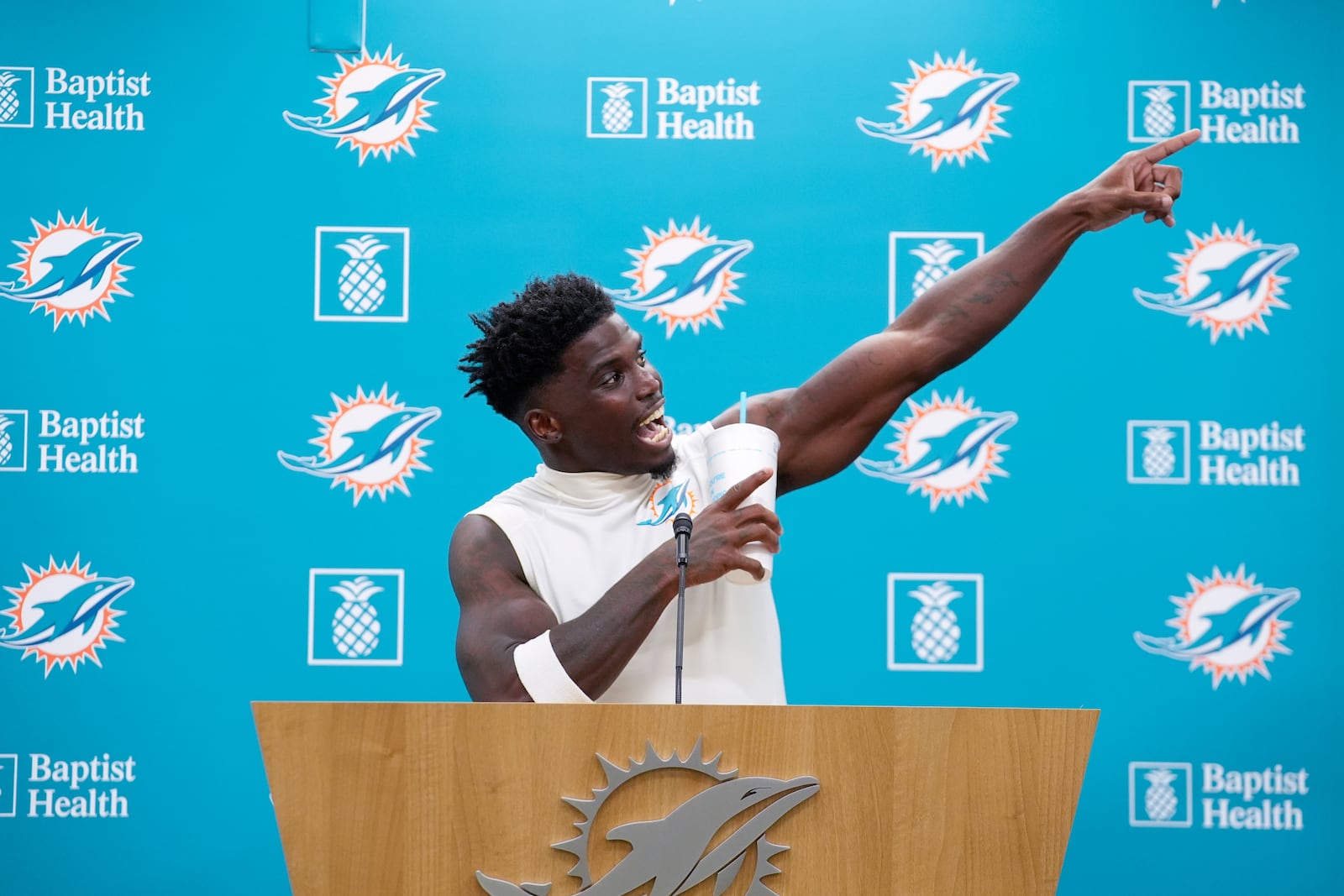 Miami Dolphins wide receiver Tyreek Hill (10) gestures as he calls for the police officer involved in his traffic stop to be fired, during a press conference following a team practice, Wednesday, Sept. 11, 2024, in Miami Gardens, Fla. (AP Photo/Rebecca Blackwell)