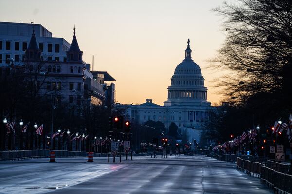 The sun rises behind the U.S. Capitol in Washington.