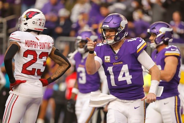 Minnesota Vikings quarterback Sam Darnold (14) celebrates after throwing a touchdown pass during the second half of an NFL football game against the Arizona Cardinals Sunday, Dec. 1, 2024, in Minneapolis. (AP Photo/Bruce Kluckhohn)