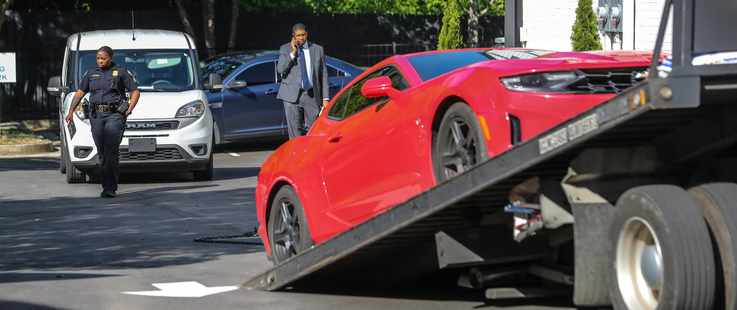 A white work van and a red Chevrolet Camaro were towed from the scene of a fatal shooting at One Riverside West located at 2030 Main Street in northwest Atlanta. 

