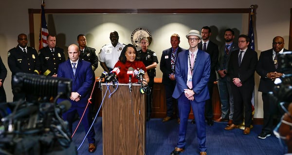 Surrounded by Fulton County law enforcement officials, District Attorney Fani Willis speaks during a press conference about the RICO indictment in the celebrity home invasion ring on Monday, August 29, 2022. (Natrice Miller/ natrice.miller@ajc.com).